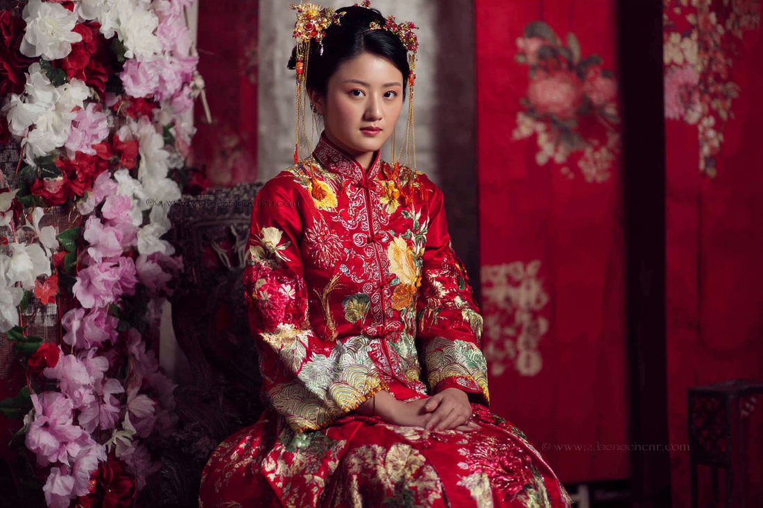 A woman wearing colourful red floral hanfu